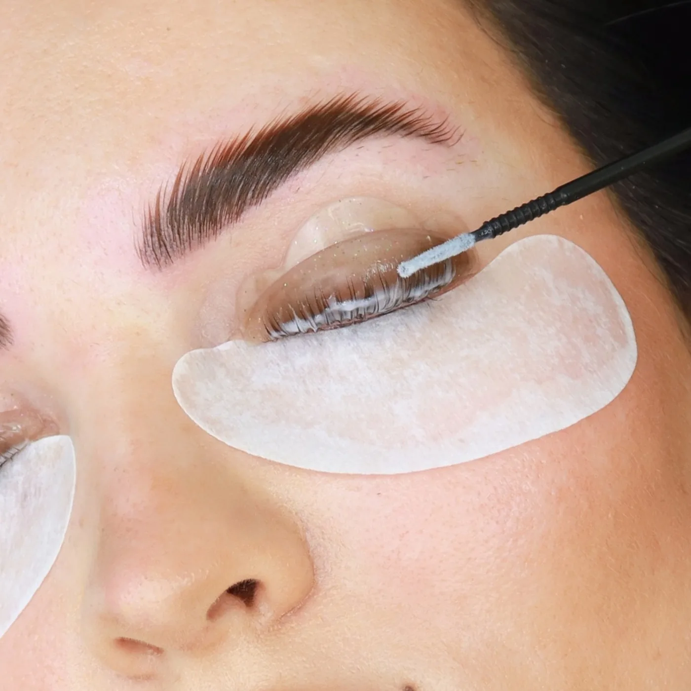 Korean lash lift in Dubai, natural lashes combed onto a silicone shield at AZIZAM beauty salon