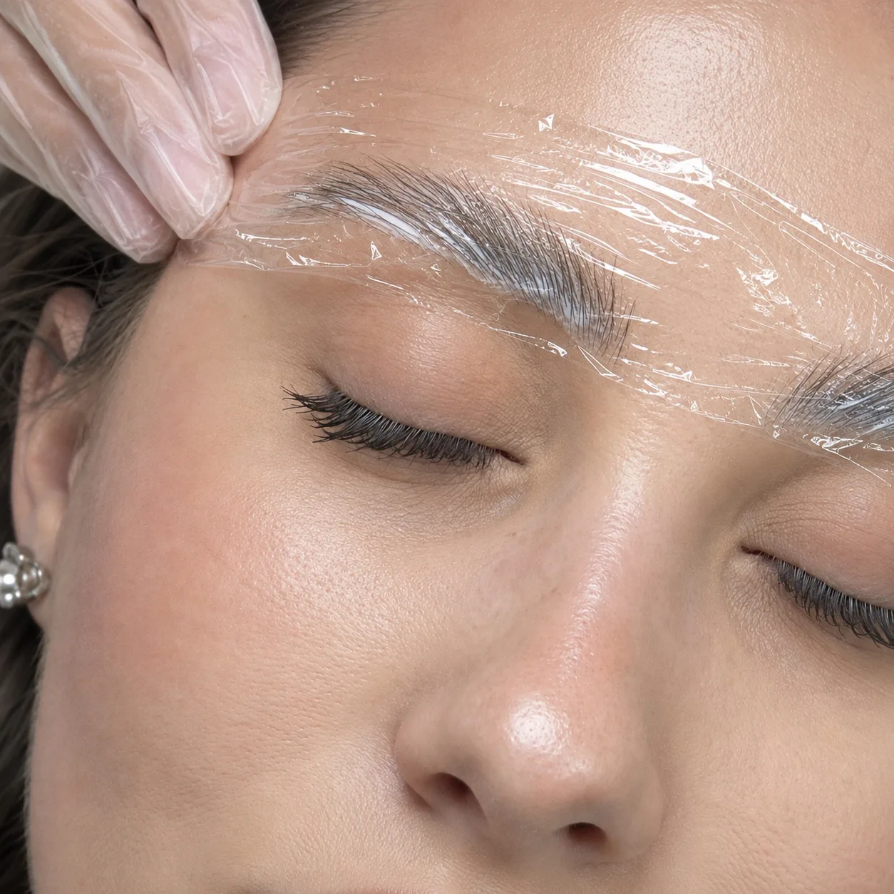 Brow lamination in Dubai, brows set under film at AZIZAM beauty salon